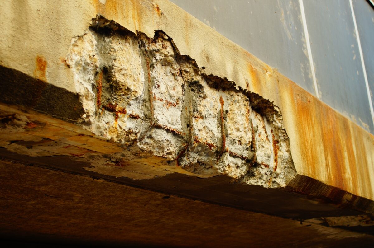 Corrosion damage on a concrete bridge.