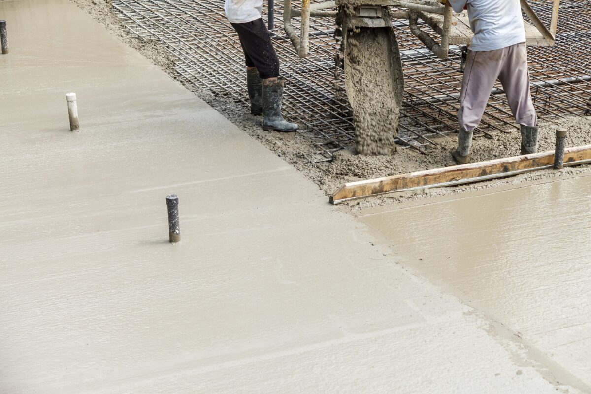 Pouring concrete into the construction of the house. Builders are pouring ready-mixed concrete